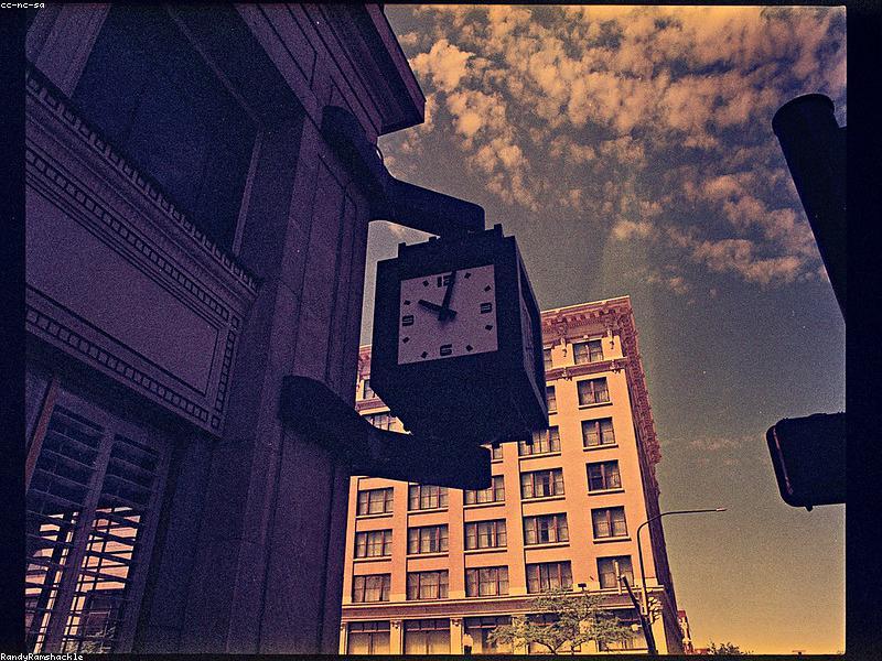 Close-up of a hand holding a smartphone showing an IPTV app with German TV channels, high resolution, modern user interface, tech-focused background